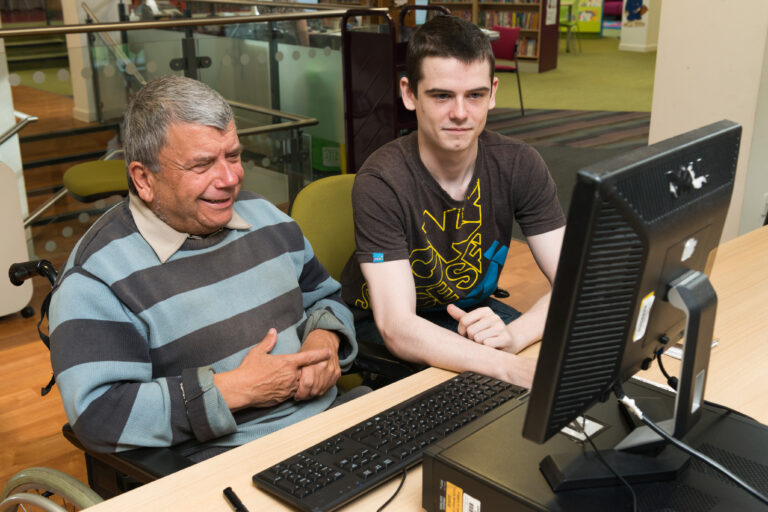 Digital volunteer helps man use library computer