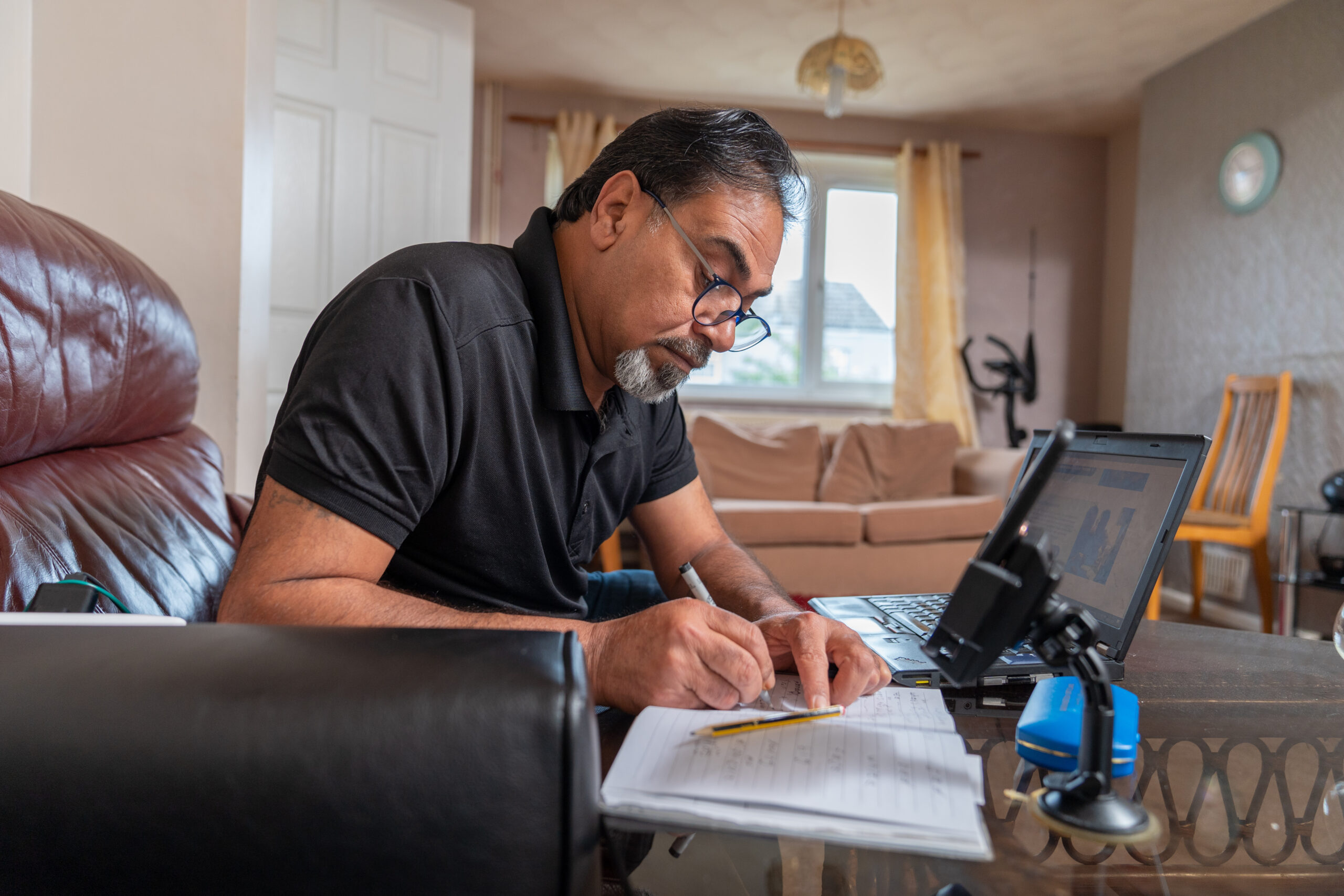 Older man using laptop to study