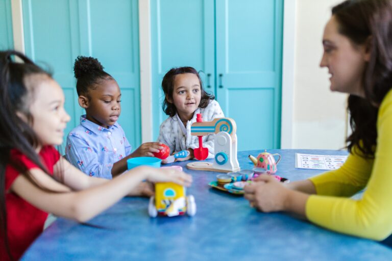 Nursery worker talking to children