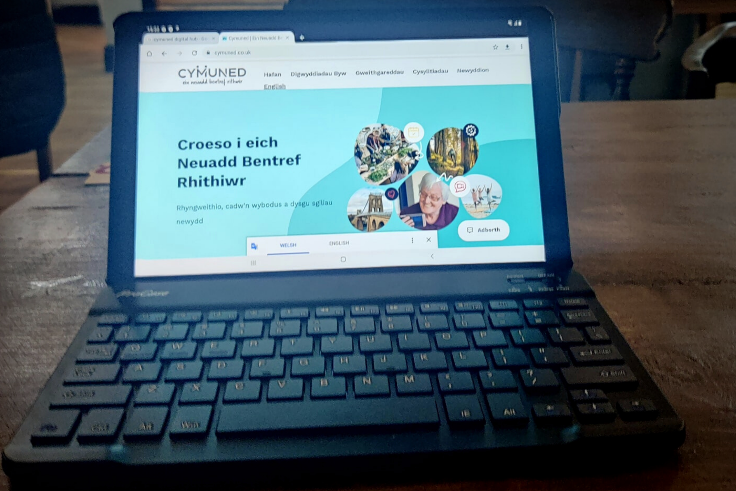 Laptop with the cymuned.co.uk website loaded