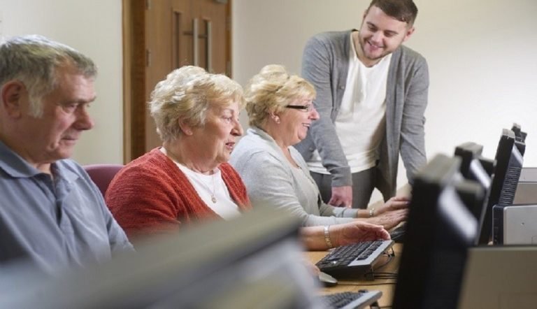 Older people sat at computers