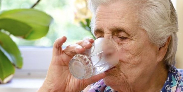 old lady drinking a glass of water