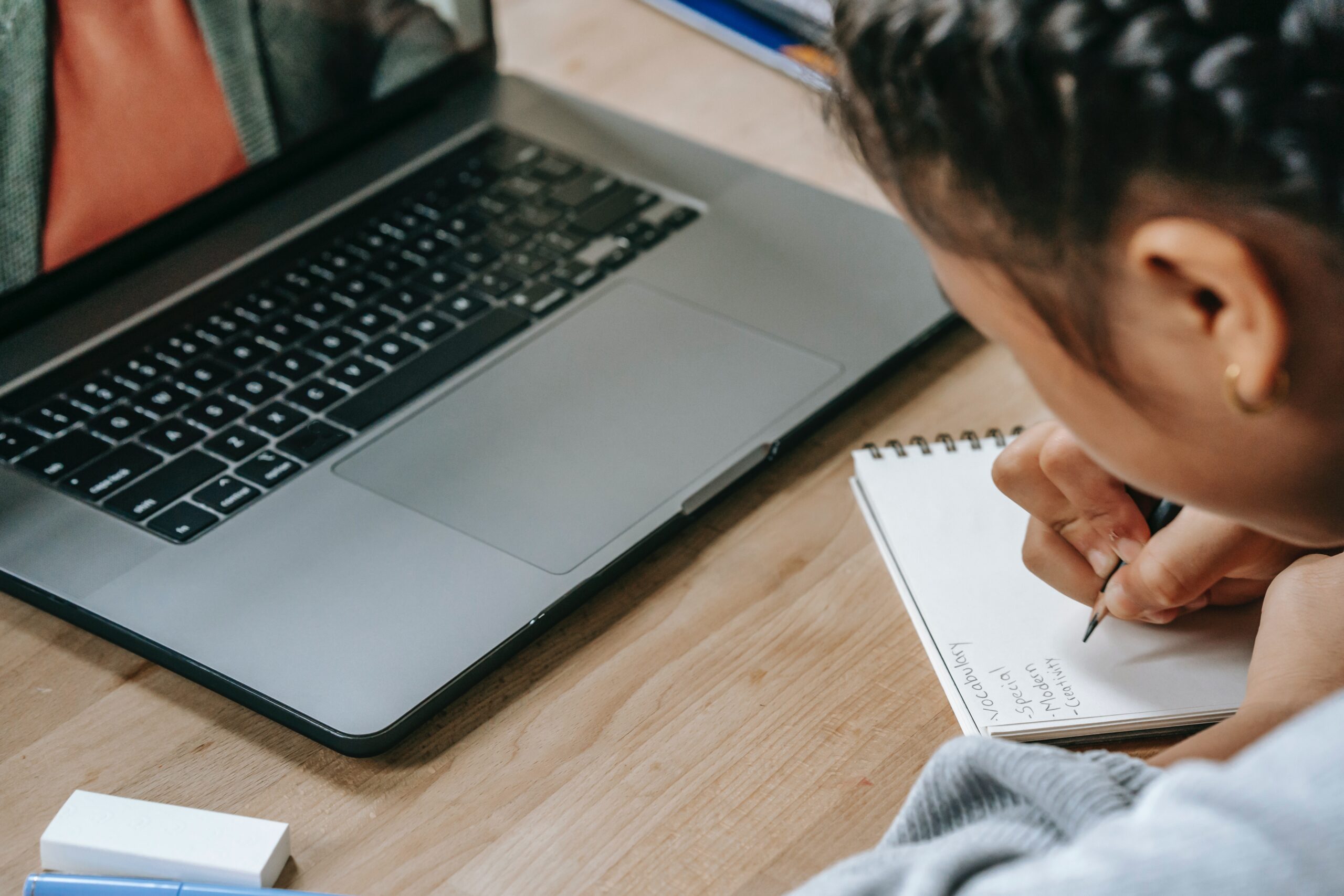 young girl using laptop for homework